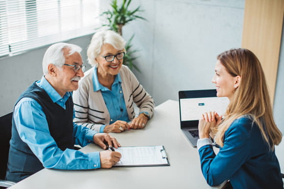 Couple speak with a representative about basic long term care insurance.