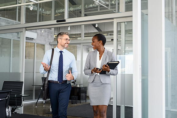 Co-workers walking in an office