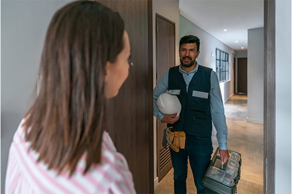 Contractor talking to a customer in their home 