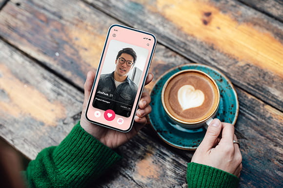 A person scrolling though a dating app on their mobile