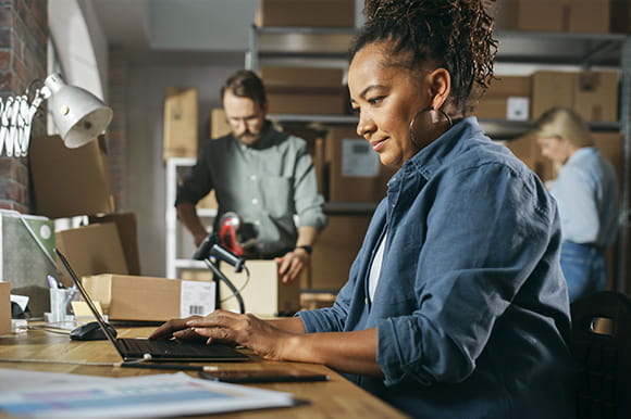 Man and a woman working at their business