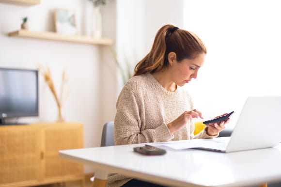A woman calculating her credit score