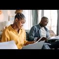 A man and a woman working on their taxes